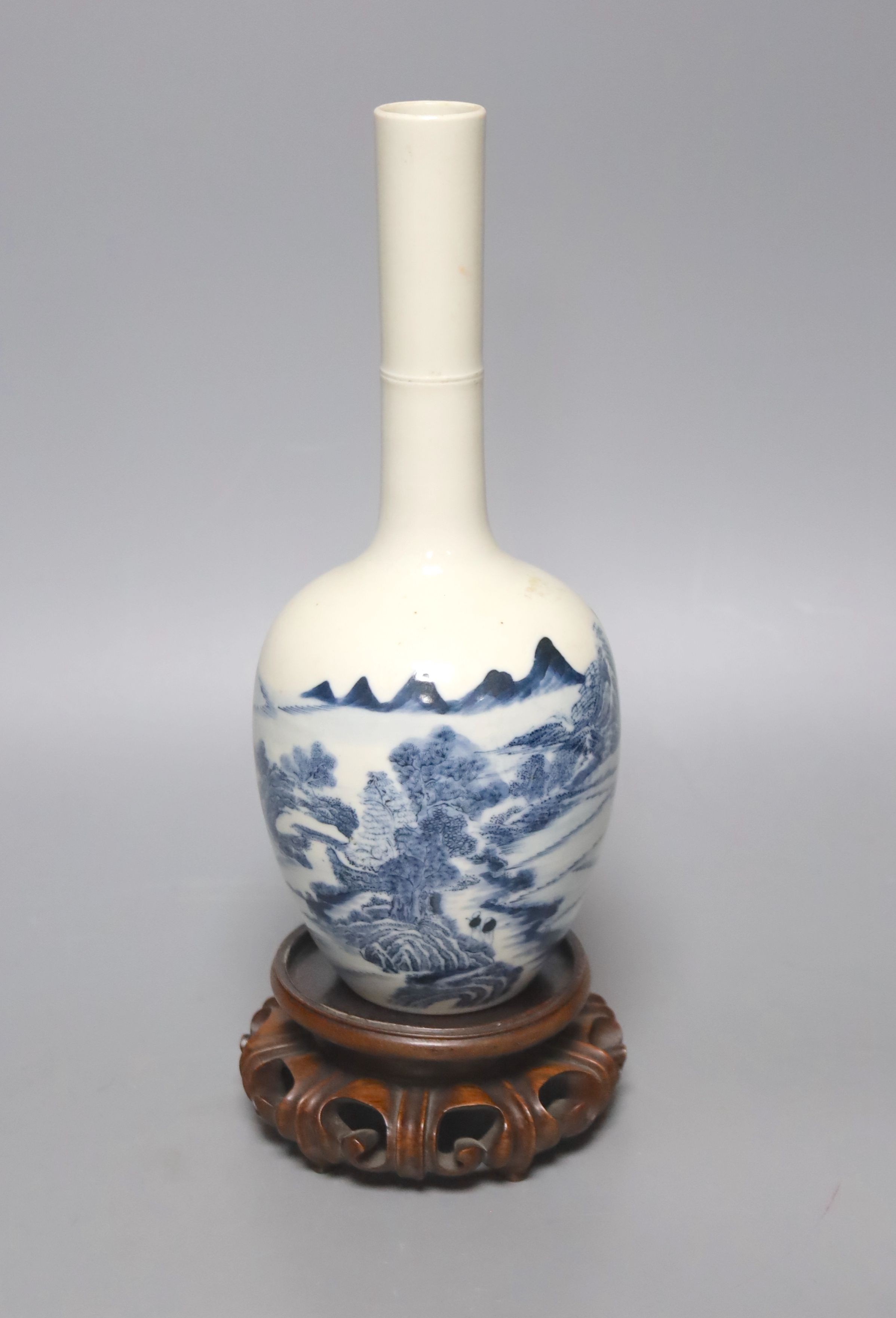 A Chinese blue and white bottle vase, with hardwood stand 23.5cm.